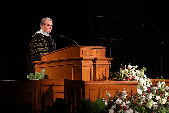 BYU-Idaho graduates gather in the I-Center to hear from Elder Carlos A. Godoy of the Seventy as he speaks at commencement.