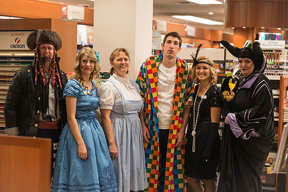 Employees of the University Store on campus stop for a photo in their Halloween costumes.