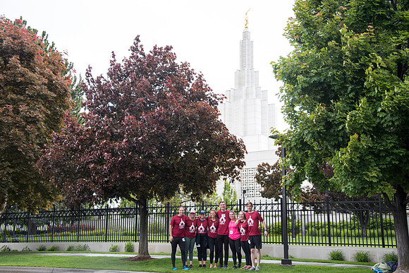After braving the unpredictable Idaho weather in June, teams celebrate crossing the finish line near the Idaho Falls Temple in the annual temple to temple relay race.