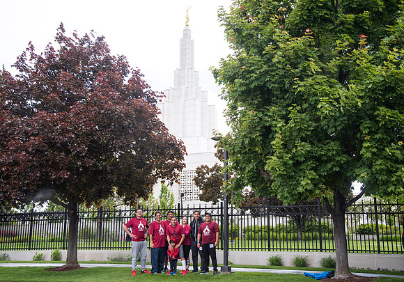 After braving the unpredictable Idaho weather in June, teams celebrate crossing the finish line near the Idaho Falls Temple in the annual temple to temple relay race.