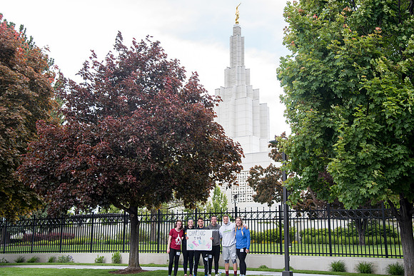 After braving the unpredictable Idaho weather in June, teams celebrate crossing the finish line near the Idaho Falls Temple in the annual temple to temple relay race.