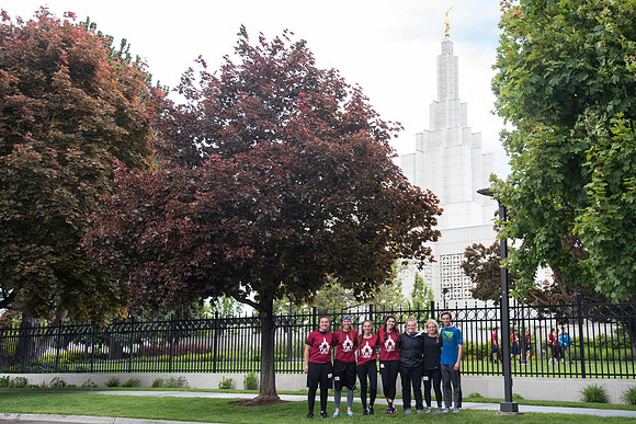 After braving the unpredictable Idaho weather in June, teams celebrate crossing the finish line near the Idaho Falls Temple in the annual temple to temple relay race.