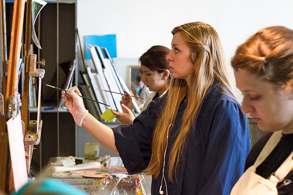 A student in Brother Bodily's Painting class paints a beautiful landcape in the Spori Building.