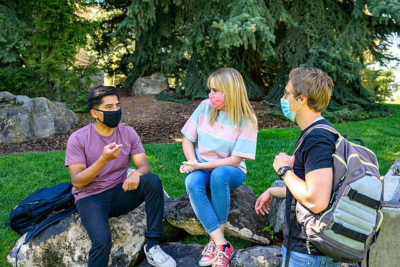 Student volunteers show the way to stay safe during this COVID 19 pandemic by social distancing, following pathway arrows and proper wearing of masks .