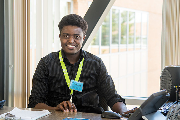Tinashe Muyengwa a Library Aide monitors patrons as they come and go into the Library from the Skywalk.