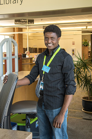 Tinashe Muyengwa a Library Aide monitors patrons as they come and go into the Library from the Skywalk.