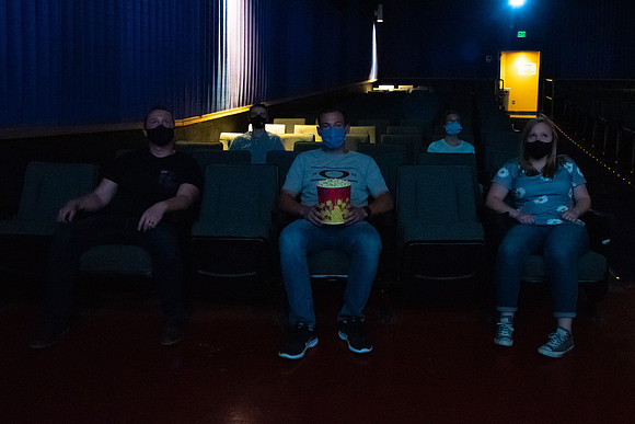 Students at a local movie theater wearing face masks.