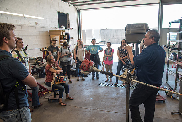 A Horticulture class takes a field trip to the Fleet Services to learn about small engine maintenance.