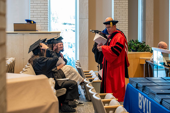 Students graduate from the College of Language and Letters. Jason Williams hands out the awards.
