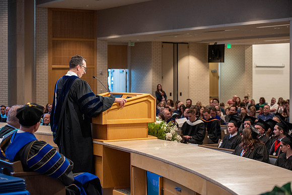 Students graduate from the College of Language and Letters. Jason Williams hands out the awards.