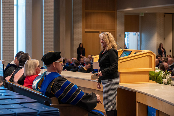 Students graduate from the College of Language and Letters. Jason Williams hands out the awards.