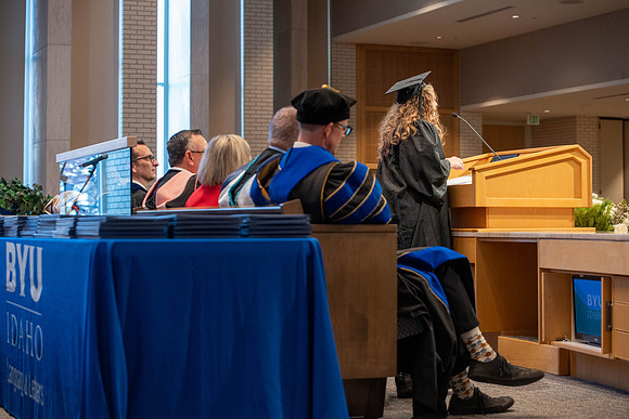 Students graduate from the College of Language and Letters. Jason Williams hands out the awards.