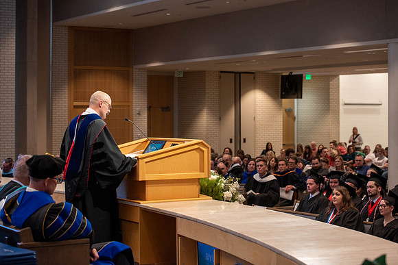 Students graduate from the College of Language and Letters. Jason Williams hands out the awards.