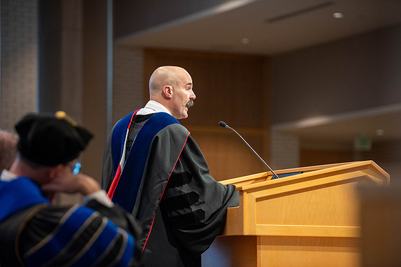 Students graduate from the College of Language and Letters. Jason Williams hands out the awards.