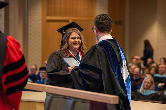 Students graduate from the College of Language and Letters. Jason Williams hands out the awards.