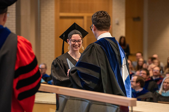 Students graduate from the College of Language and Letters. Jason Williams hands out the awards.