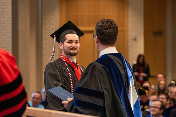 Students graduate from the College of Language and Letters. Jason Williams hands out the awards.