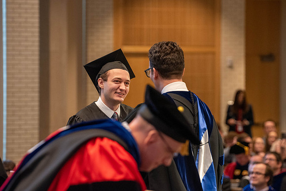 Students graduate from the College of Language and Letters. Jason Williams hands out the awards.