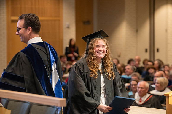Students graduate from the College of Language and Letters. Jason Williams hands out the awards.