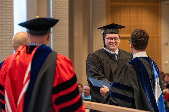 Students graduate from the College of Language and Letters. Jason Williams hands out the awards.