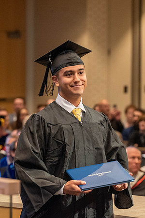Students graduate from the College of Language and Letters. Jason Williams hands out the awards.