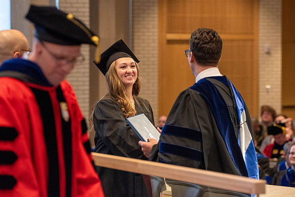 Students graduate from the College of Language and Letters. Jason Williams hands out the awards.