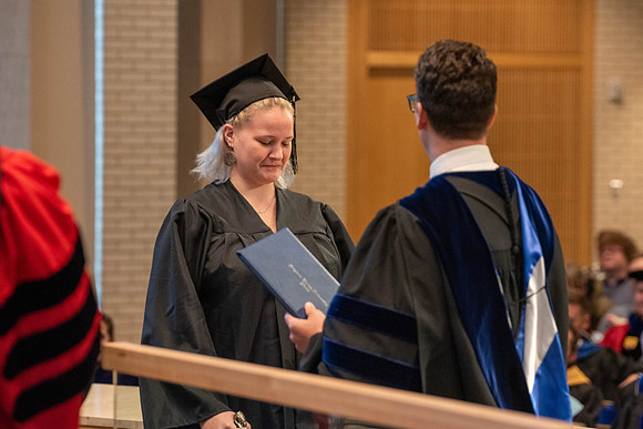 Students graduate from the College of Language and Letters. Jason Williams hands out the awards.