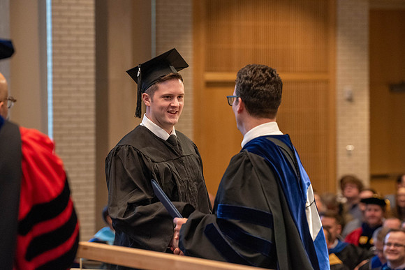 Students graduate from the College of Language and Letters. Jason Williams hands out the awards.