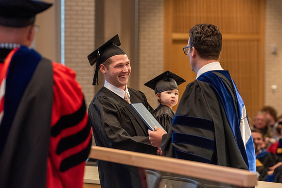 Students graduate from the College of Language and Letters. Jason Williams hands out the awards.