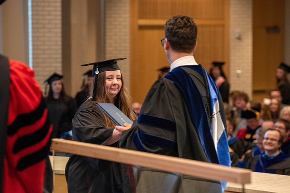 Students graduate from the College of Language and Letters. Jason Williams hands out the awards.