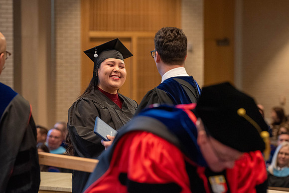 Students graduate from the College of Language and Letters. Jason Williams hands out the awards.