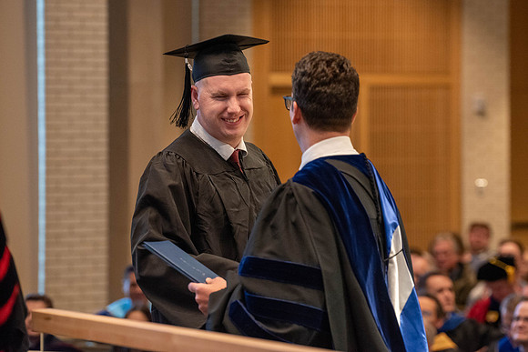 Students graduate from the College of Language and Letters. Jason Williams hands out the awards.