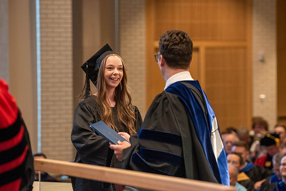 Students graduate from the College of Language and Letters. Jason Williams hands out the awards.