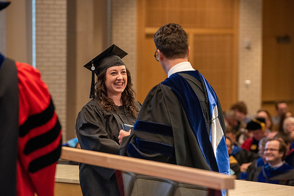 Students graduate from the College of Language and Letters. Jason Williams hands out the awards.