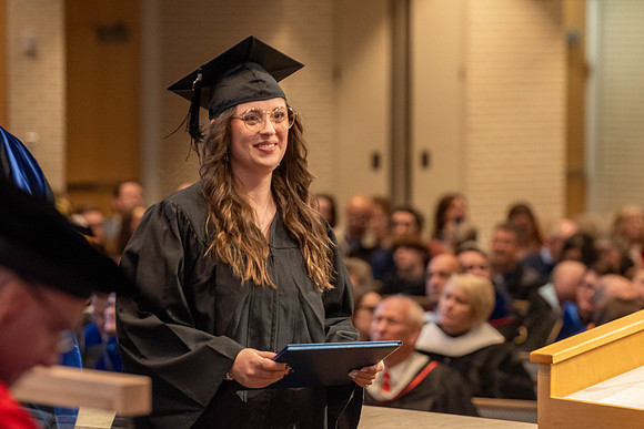 Students graduate from the College of Language and Letters. Jason Williams hands out the awards.