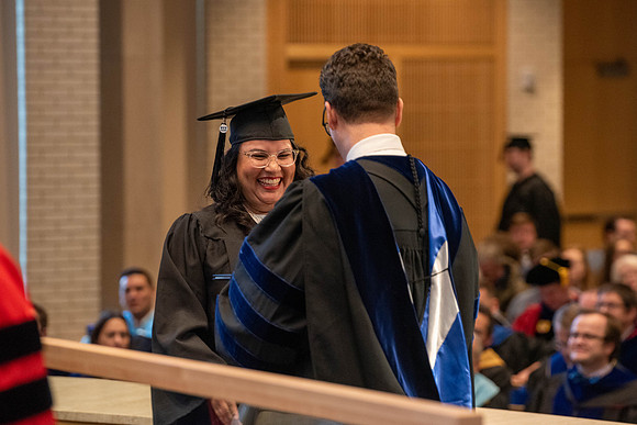 Students graduate from the College of Language and Letters. Jason Williams hands out the awards.