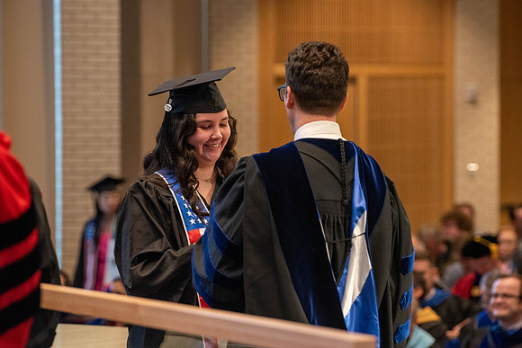Students graduate from the College of Language and Letters. Jason Williams hands out the awards.