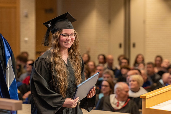 Students graduate from the College of Language and Letters. Jason Williams hands out the awards.