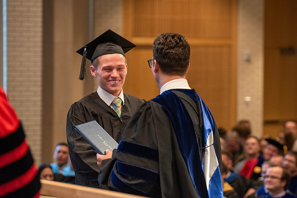 Students graduate from the College of Language and Letters. Jason Williams hands out the awards.