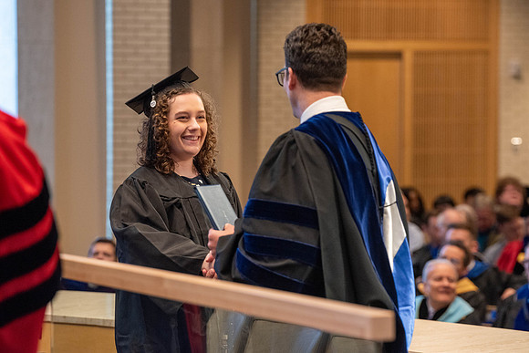 Students graduate from the College of Language and Letters. Jason Williams hands out the awards.