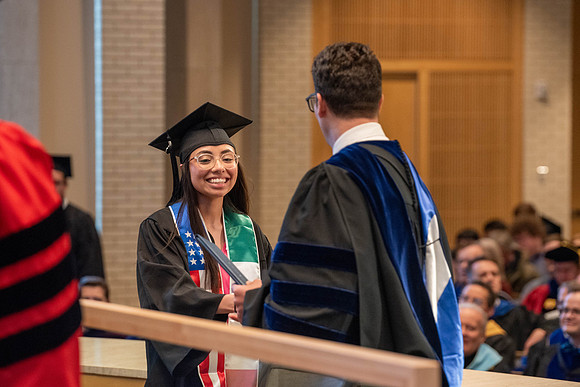 Students graduate from the College of Language and Letters. Jason Williams hands out the awards.