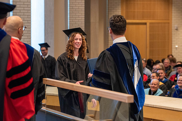 Students graduate from the College of Language and Letters. Jason Williams hands out the awards.