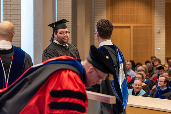Students graduate from the College of Language and Letters. Jason Williams hands out the awards.