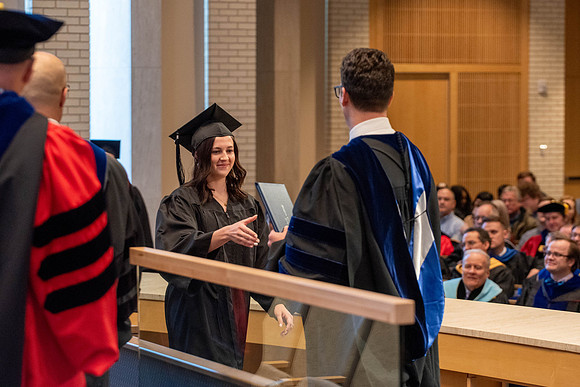 Students graduate from the College of Language and Letters. Jason Williams hands out the awards.