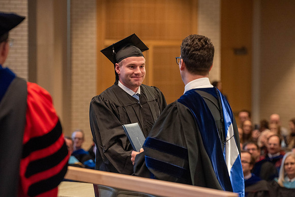 Students graduate from the College of Language and Letters. Jason Williams hands out the awards.