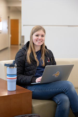 A student works hard on her class assignments in the Science and Technology Center.