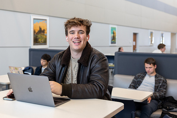 A student works hard on his class assignments in the Science and Technology Center.