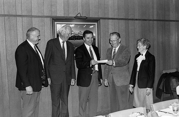 Former FBI agent makes donation to Ricks College; recieved by President Steven D Bennion.