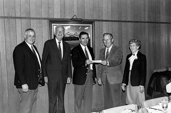 Former FBI agent makes donation to Ricks College; recieved by President Steven D Bennion.