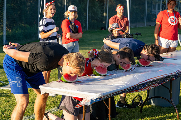 Students gather at the upper field for various 4th of July activities.